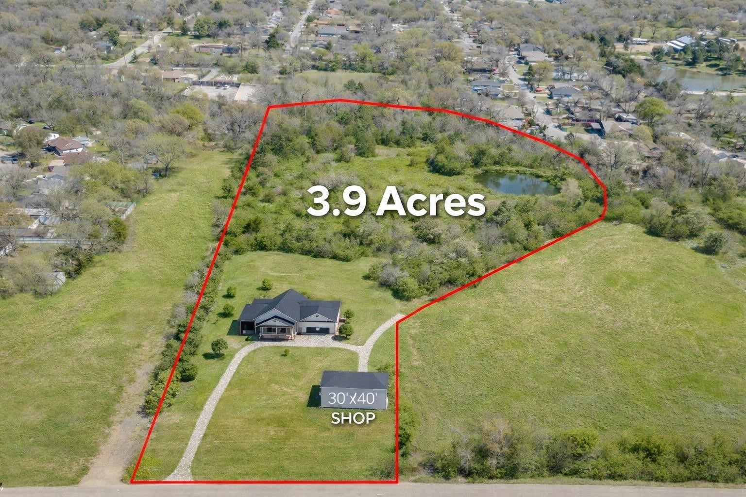 Aerial view of a 3.9-acre property with a house, shop, pond, and red boundary outline.