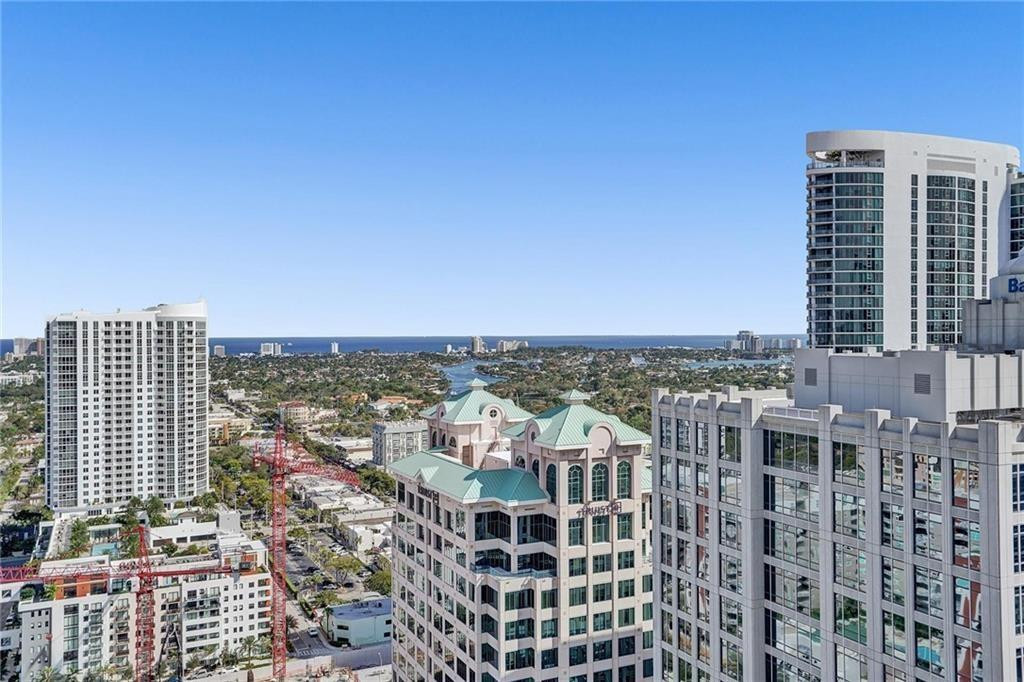 Fort Lauderdale skyline and ocean viewed between high-rise buildings.
