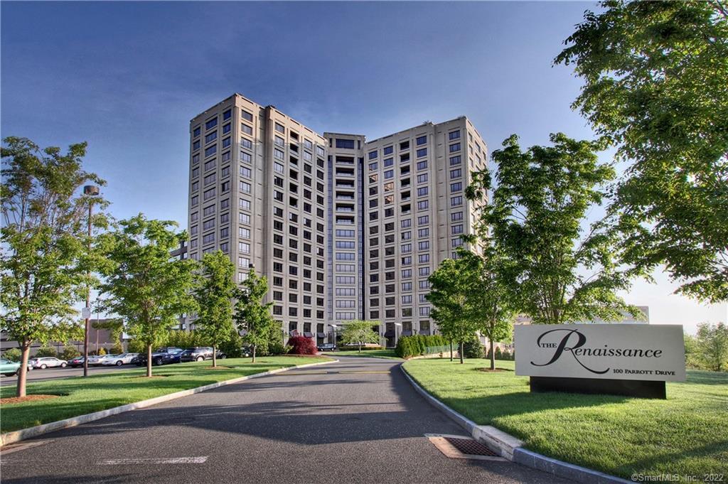 The Renaissance residential tower at the end of a landscaped driveway, with its entrance sign in the foreground.