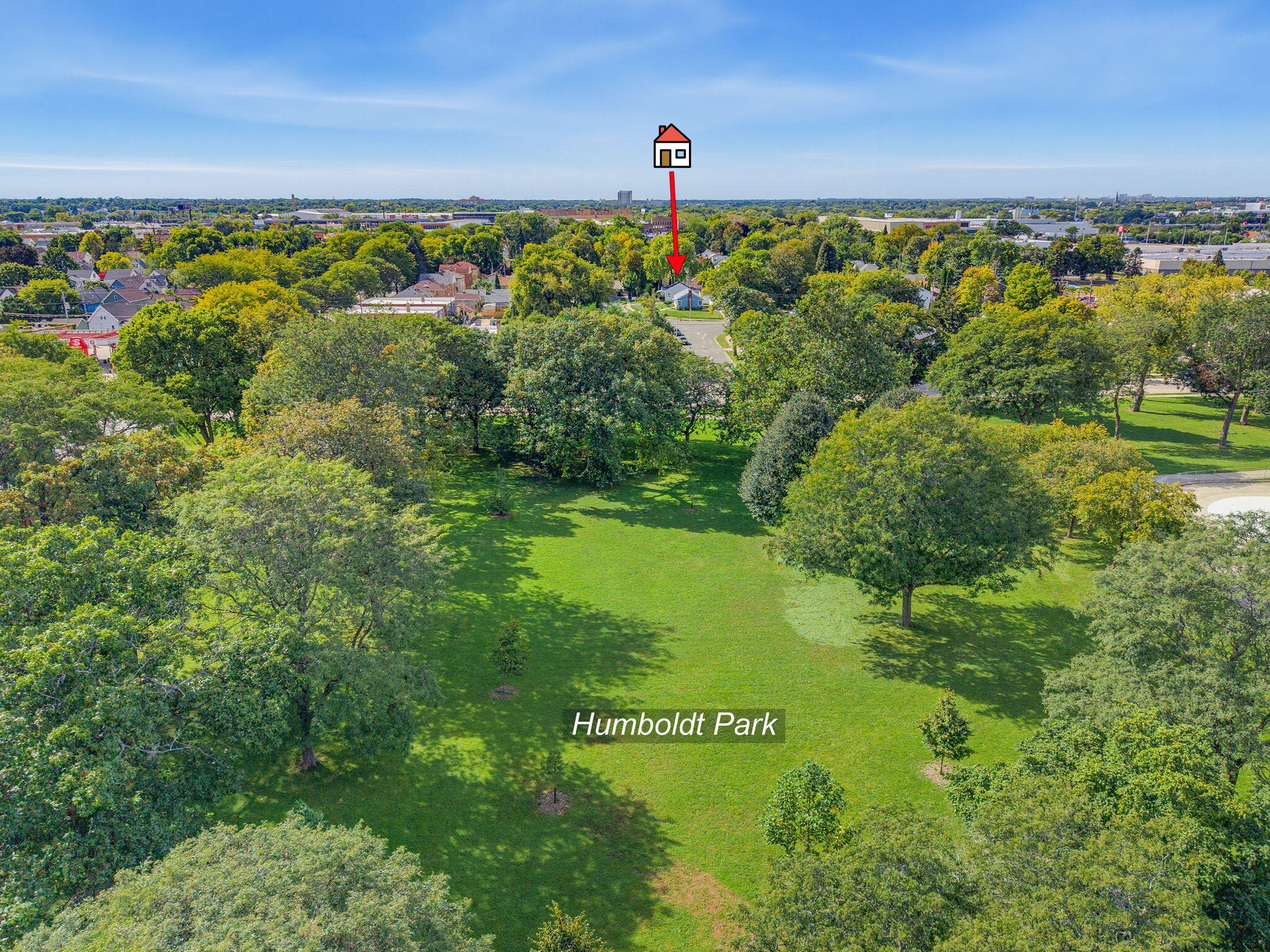 Aerial view of Humboldt Park, with an arrow marking a house beside the tree-lined park.