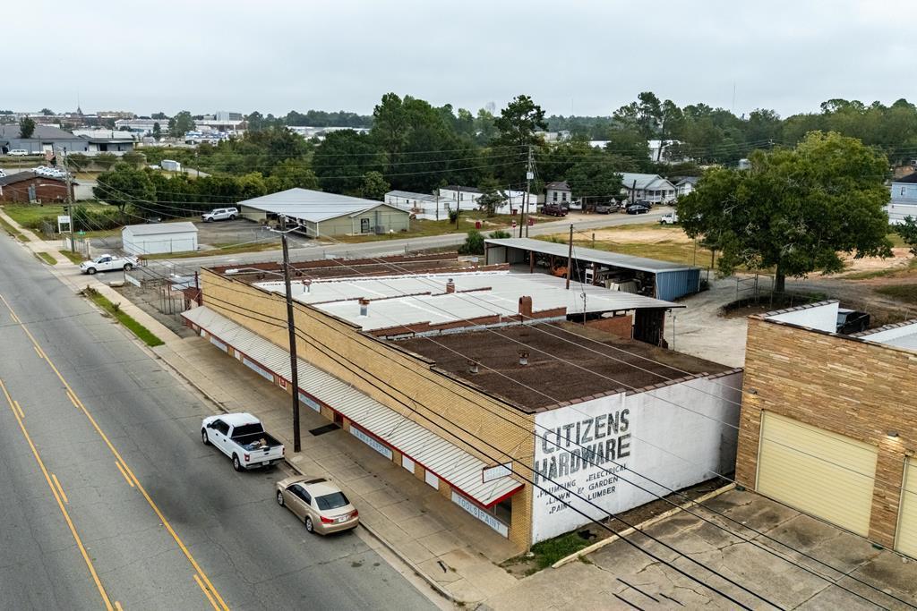 Brick Citizens Hardware building viewed from above beside a street.