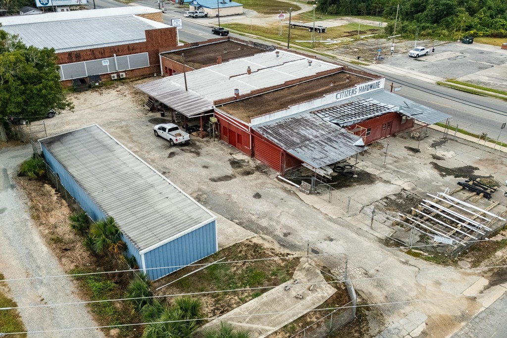 Citizens Hardware commercial property with a red building, blue metal outbuilding, and paved yard.