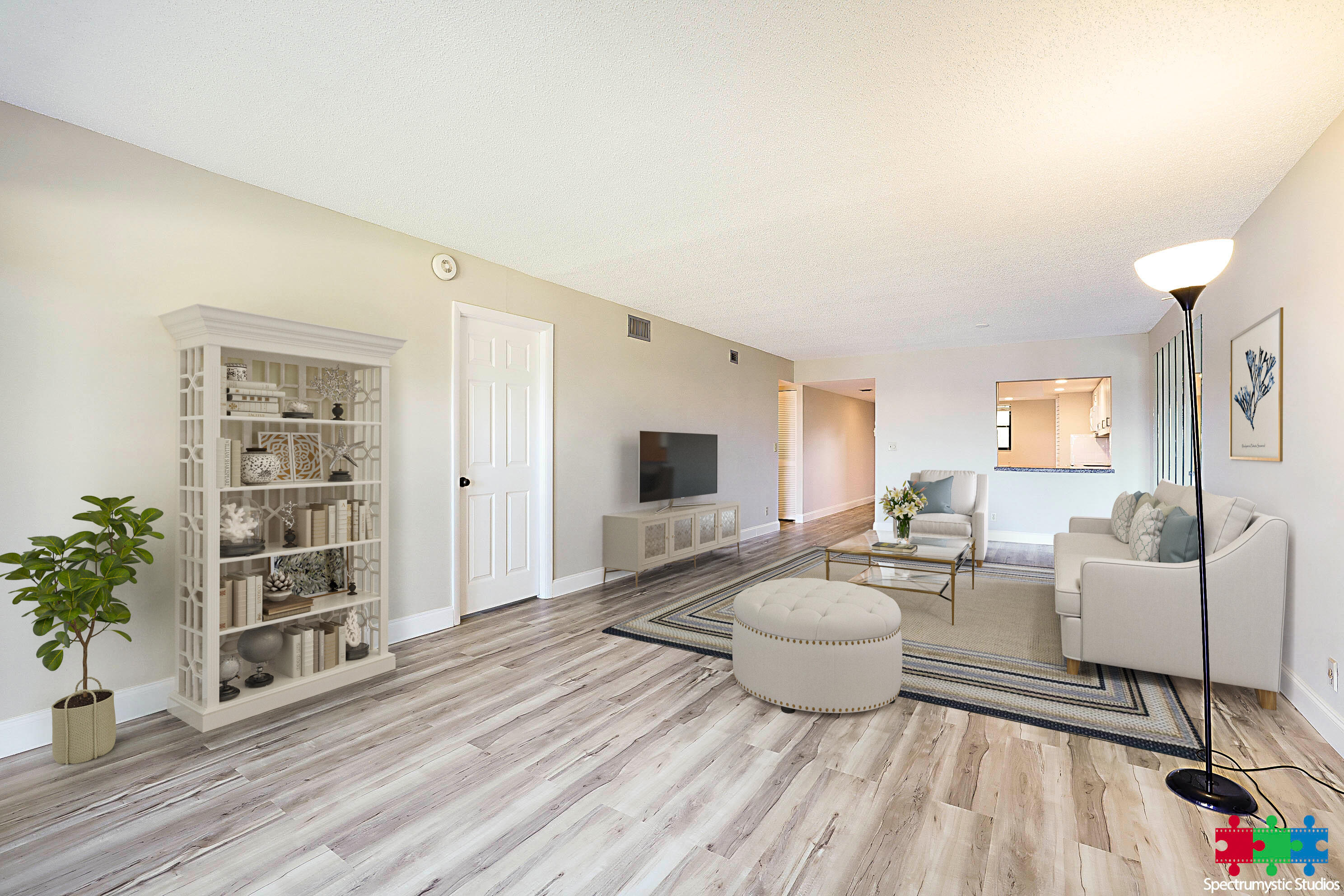 Staged living room with pale sofas, a decorative bookcase, and wood-look flooring.