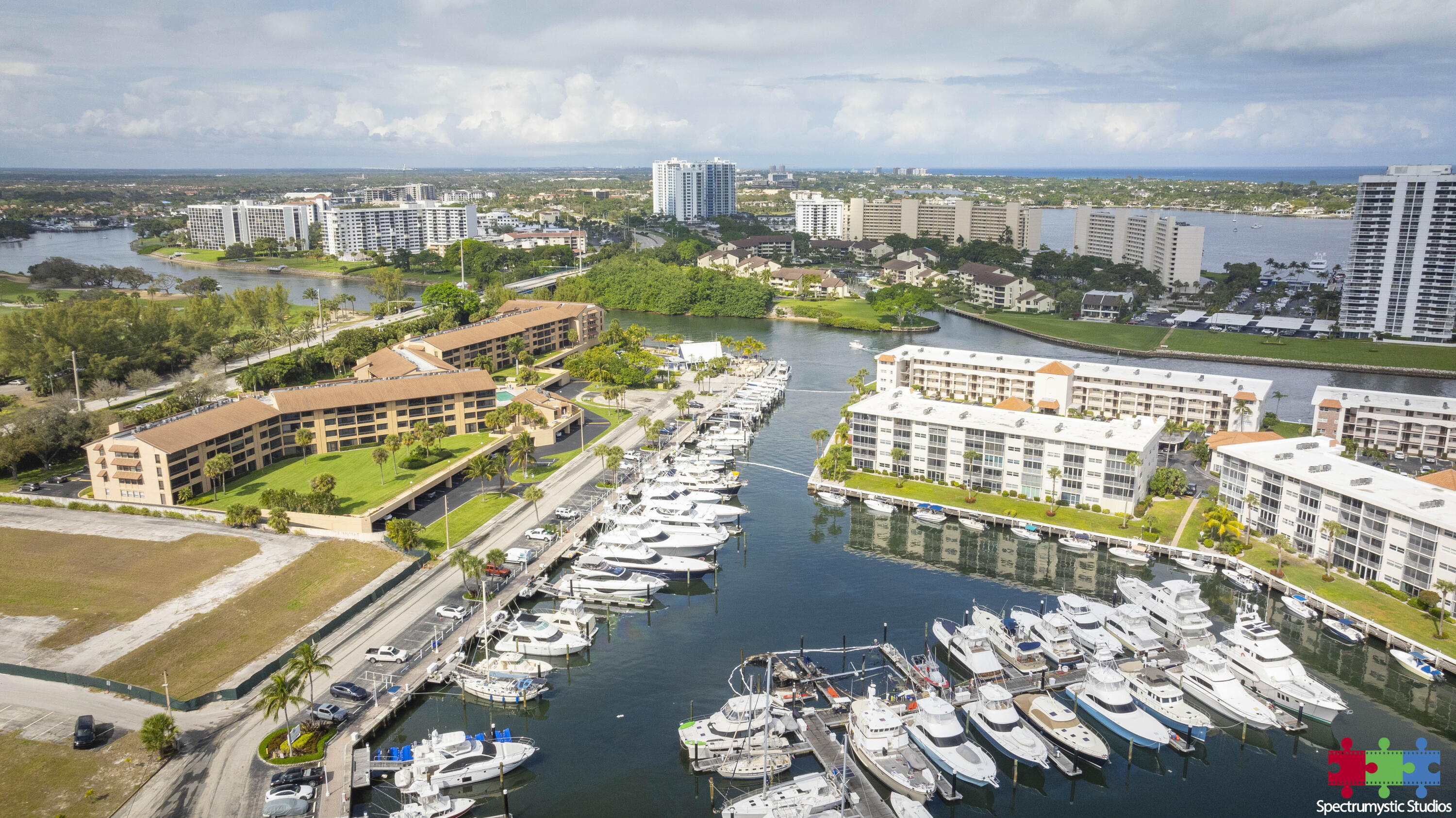 Aerial view of a marina crowded with boats, surrounded by waterfront condominium buildings.