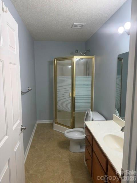 Bathroom with a gold-framed glass shower enclosure and a wood vanity.