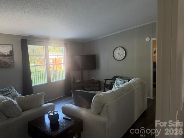Furnished living room with gray sofas, a dark coffee table, and a wall-mounted television.