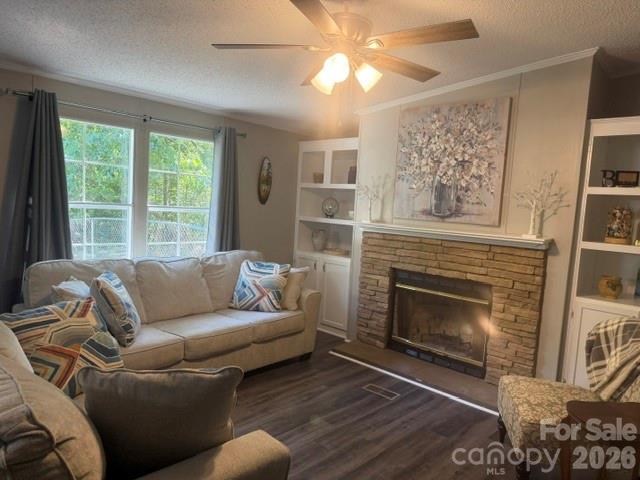 Living room with a brick fireplace, built-in shelves, and a light-colored sectional sofa.