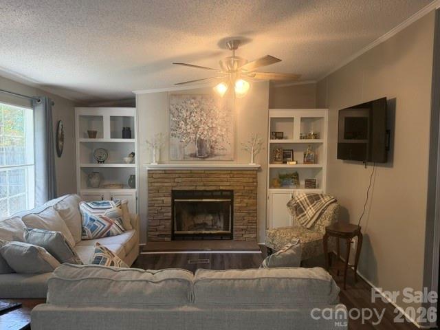 Furnished living room with brick fireplace, built-in shelves, and wall-mounted television.