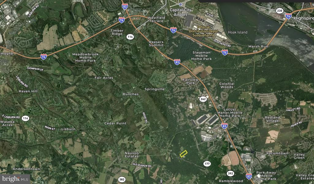 Aerial map with a small parcel outlined in yellow near Ridge Road and Old Quaker Road.