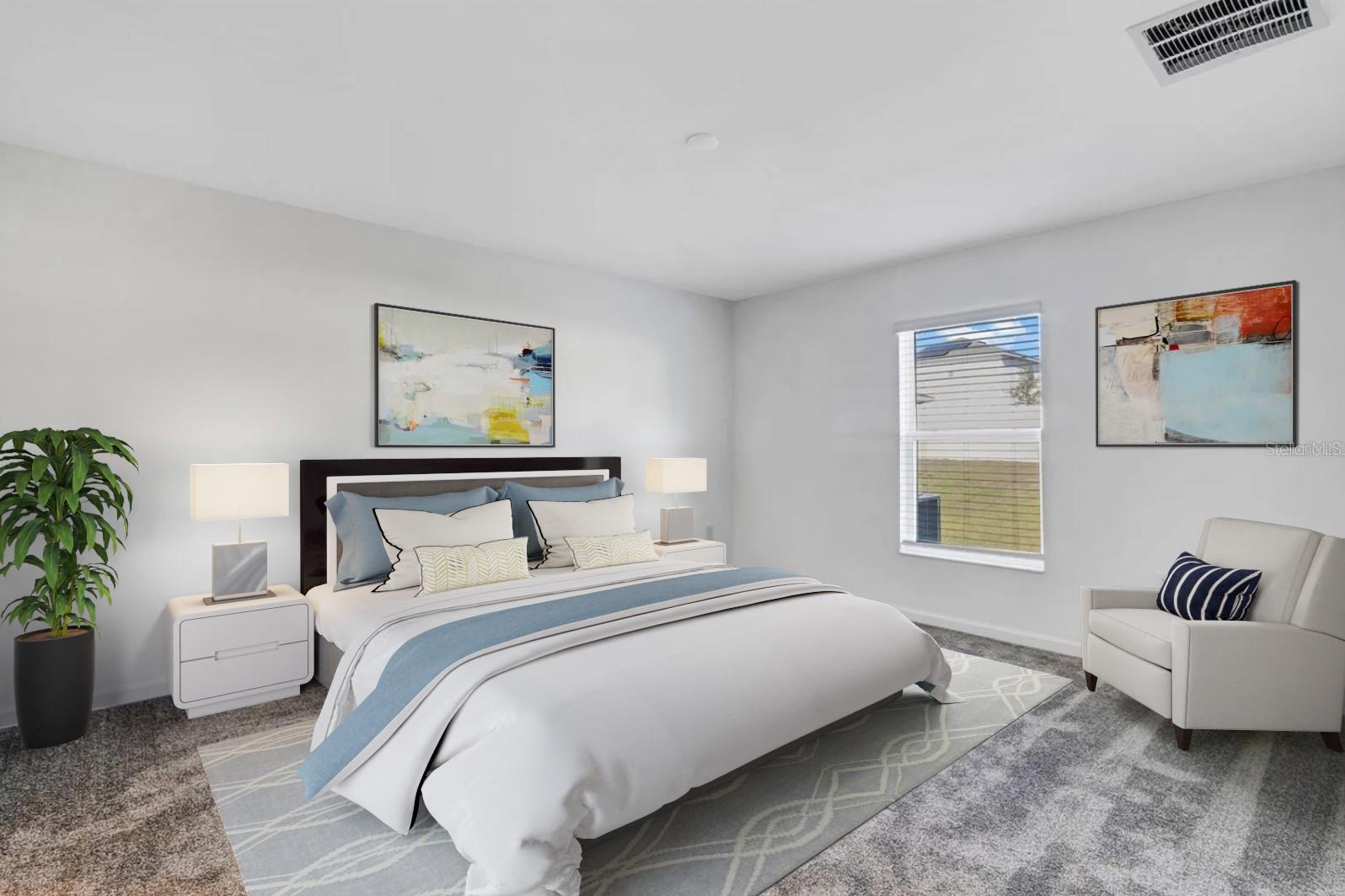 Staged bedroom with a white-and-blue bed, abstract artwork, and an armchair beside the window.