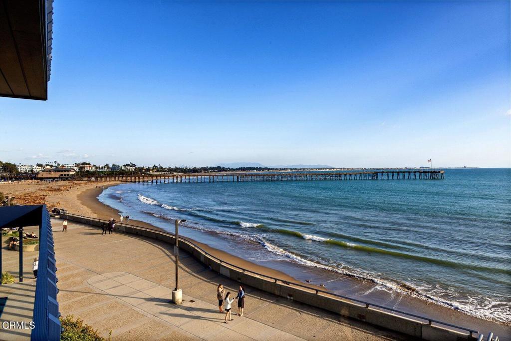 Oceanfront view of Ventura beach, pier, and seaside promenade from a balcony.