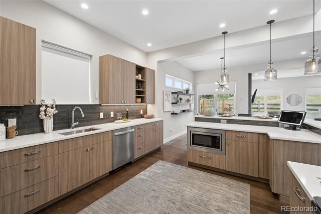 Kitchen with wood-grain cabinets, dark tile backsplash, and a central island.