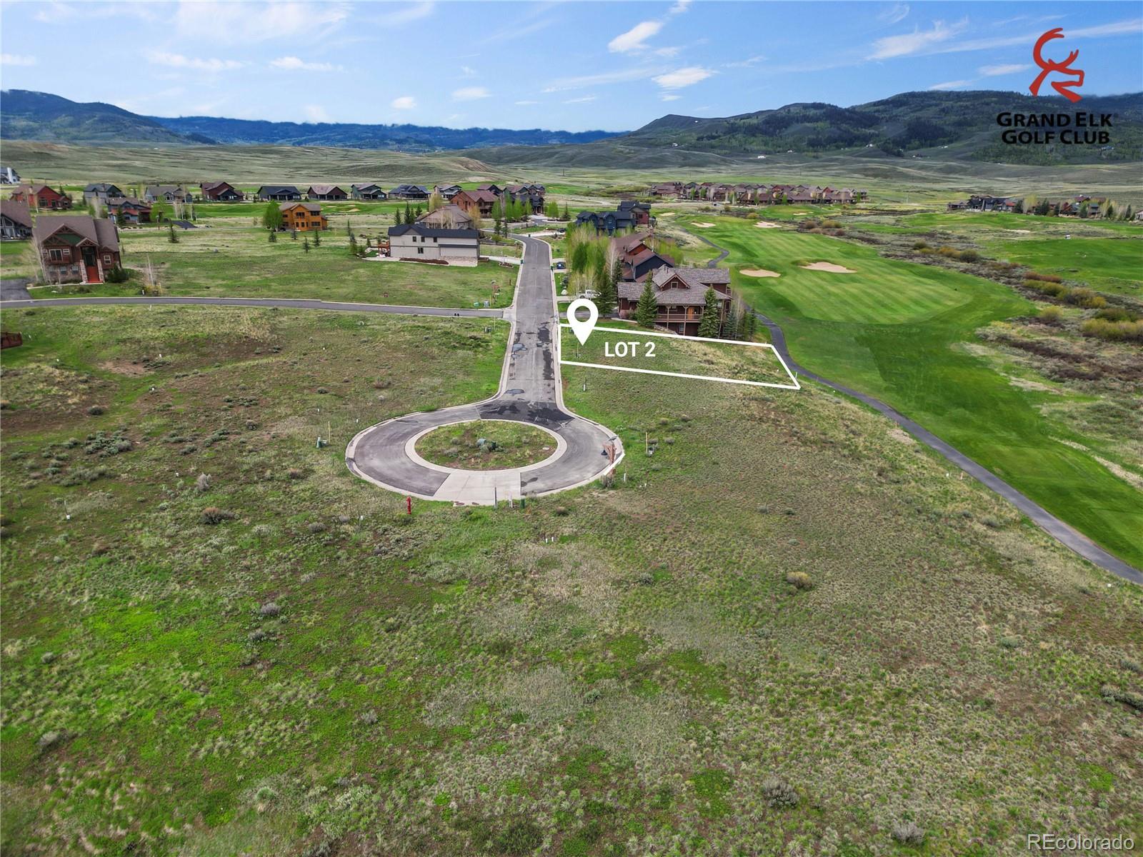 Vacant Lot 2 beside a golf course, with mountain views and a nearby cul-de-sac.