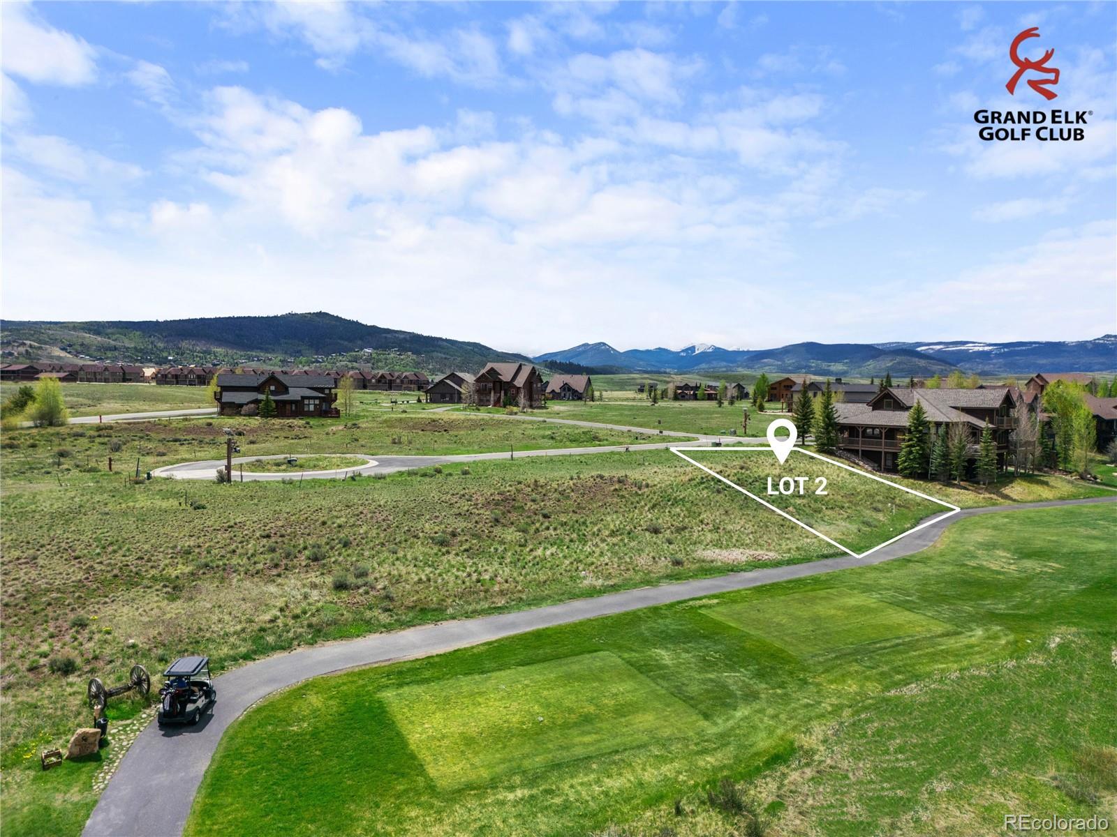 Vacant Lot 2 beside a golf course, with surrounding homes and mountain views.