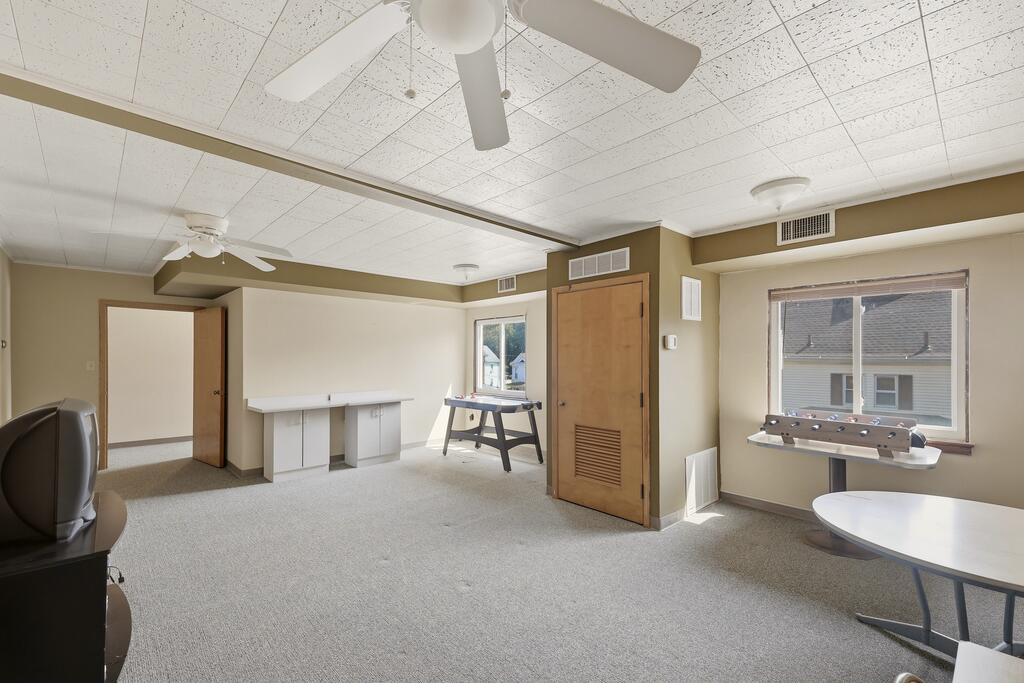 Recreation room with foosball table, tabletop game, and carpeted floor.