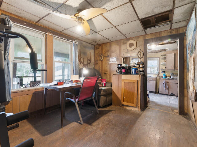 Workspace with a red chair, desk, coffee counter, and doorway to the kitchen.