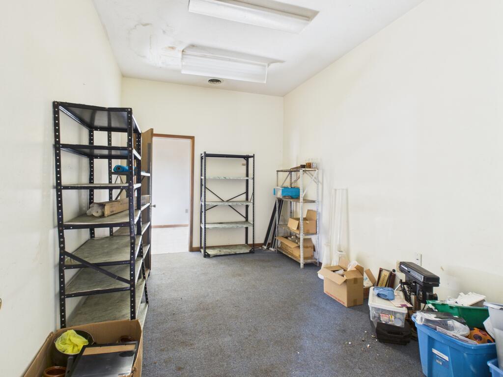 Storage room with metal shelving and boxes along the walls.