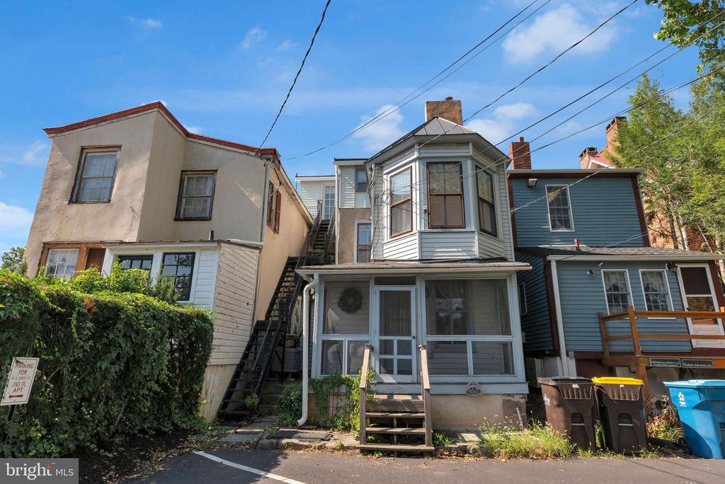 Attached home with a projecting bay window, enclosed front porch, and exterior staircase.