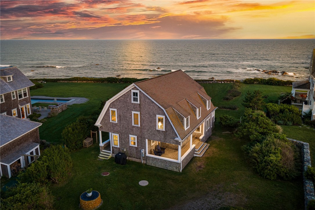 5 Kempton Place beside the ocean, with a shingled home and landscaped grounds at sunset.
