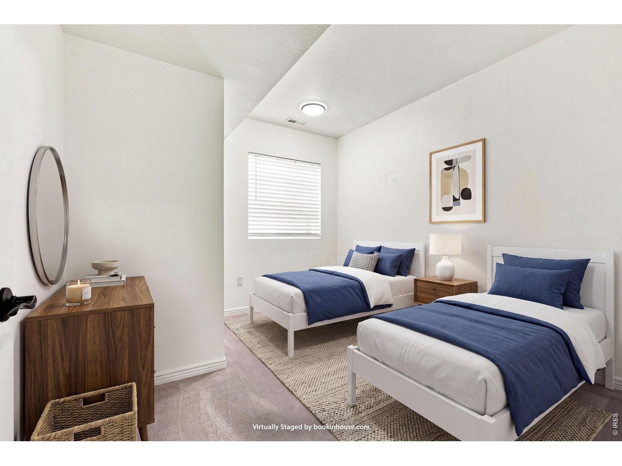 Bedroom with two white beds dressed in navy blue bedding and a wood dresser.