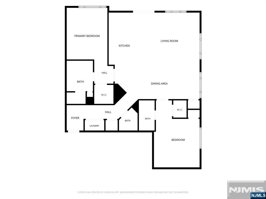 Floor plan showing two bedrooms, living and dining areas, kitchen, bathrooms, closets, foyer, and laundry.