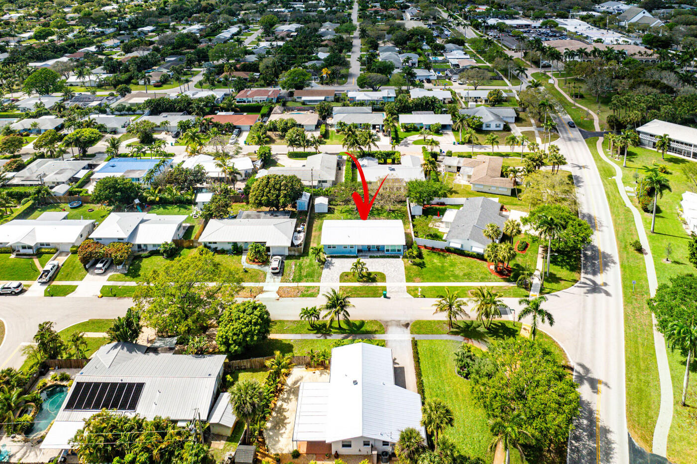 Aerial view of 371 Saturn Avenue, marked by a red arrow among neighboring homes.