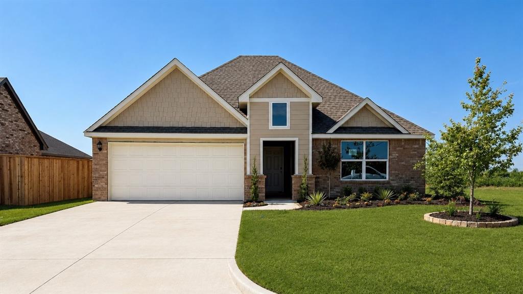 Single-story house with a two-car garage, brick accents, and a landscaped lawn.