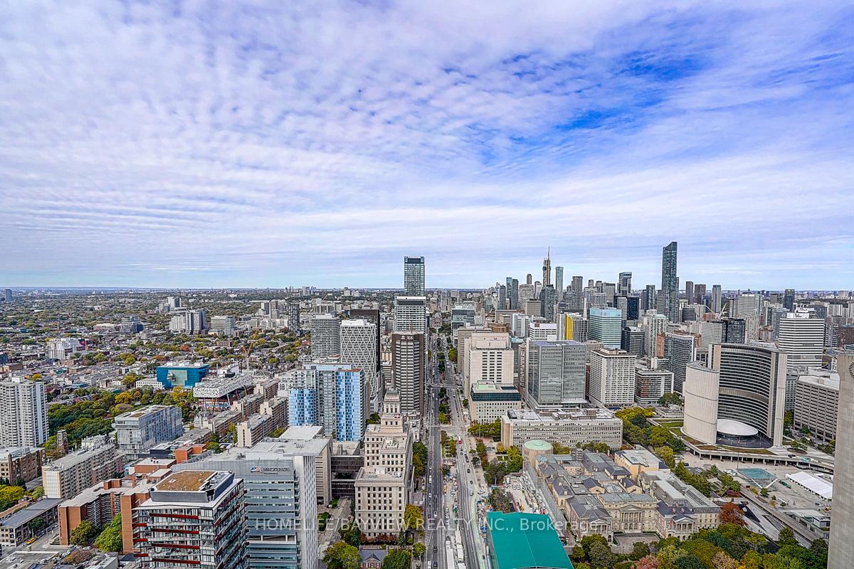 Aerial view of downtown Toronto with the CN Tower rising above the surrounding skyline.
