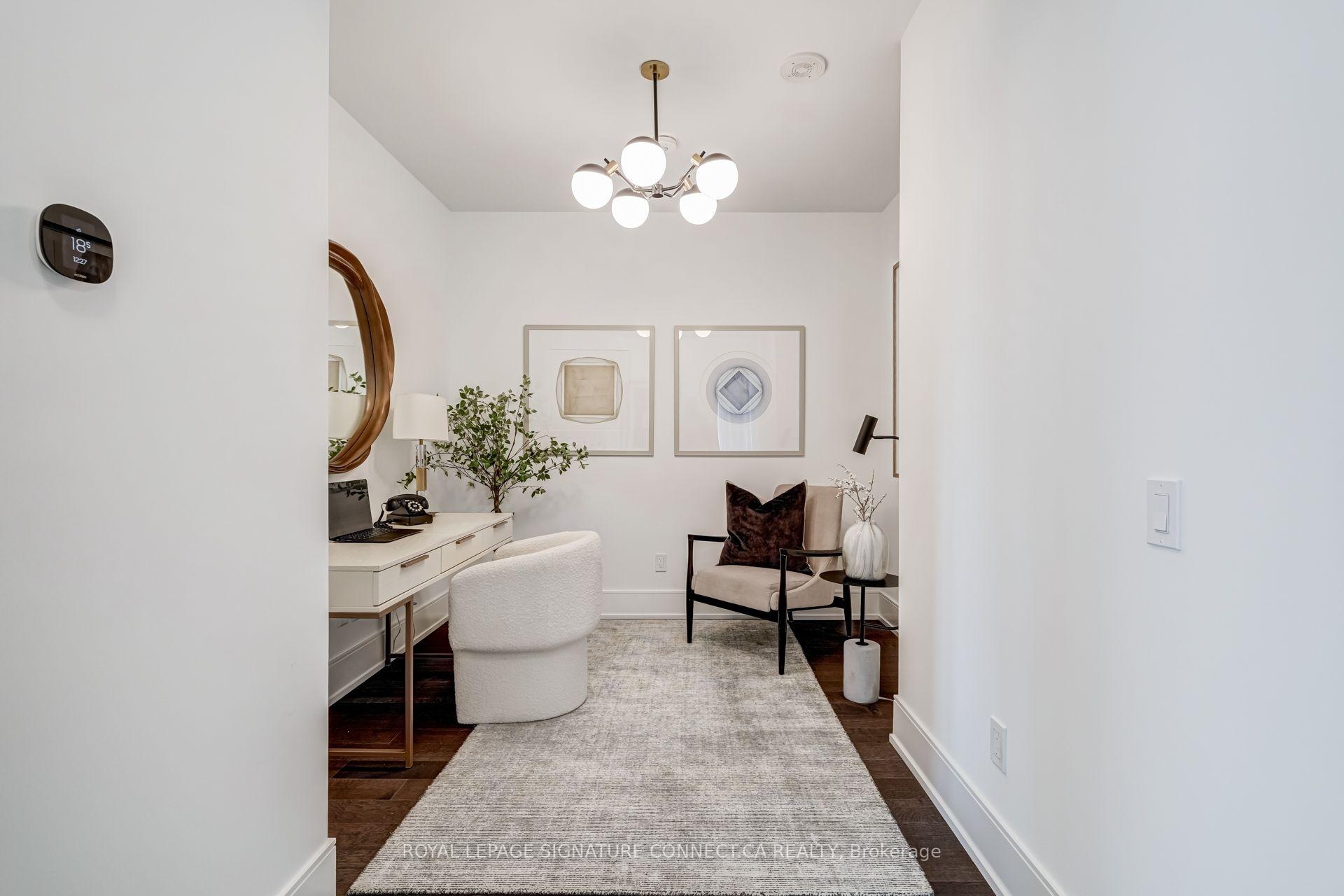 Staged home office with a white desk, boucle chair, and upholstered reading chair.