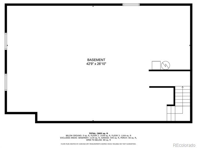 Basement floor plan with a large open area and staircase at the lower right.
