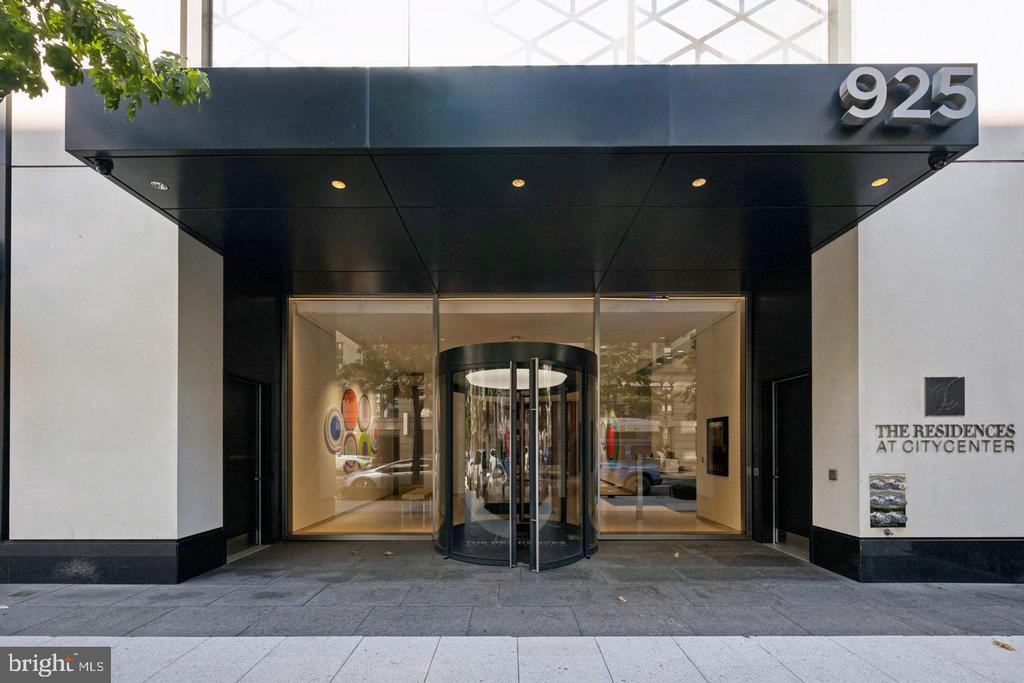 The Residences at CityCenter entrance with a black 925 canopy and glass revolving door.