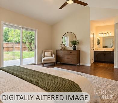 Furnished bedroom with a green bed runner, sliding doors to a fenced yard, and an adjoining bathroom vanity.