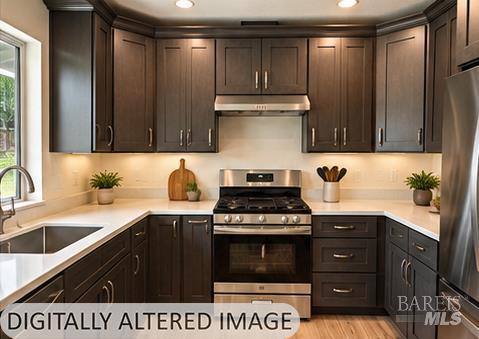 U-shaped kitchen with dark wood cabinets, white countertops, and stainless steel appliances.