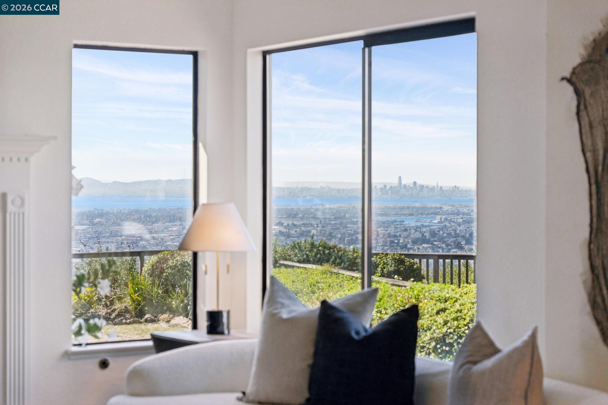 Living room with expansive windows overlooking the Bay and San Francisco skyline.