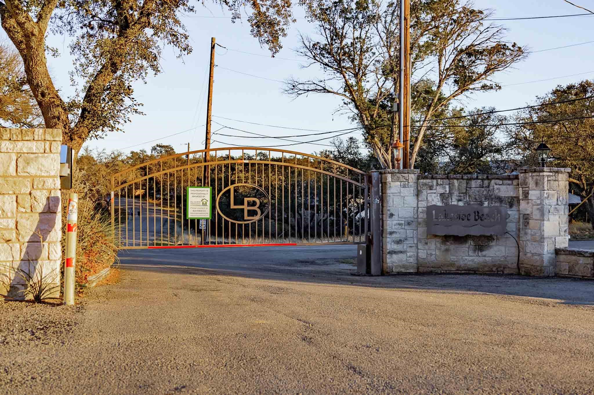 Lakeside Beach entrance with an arched metal gate and stone community sign.
