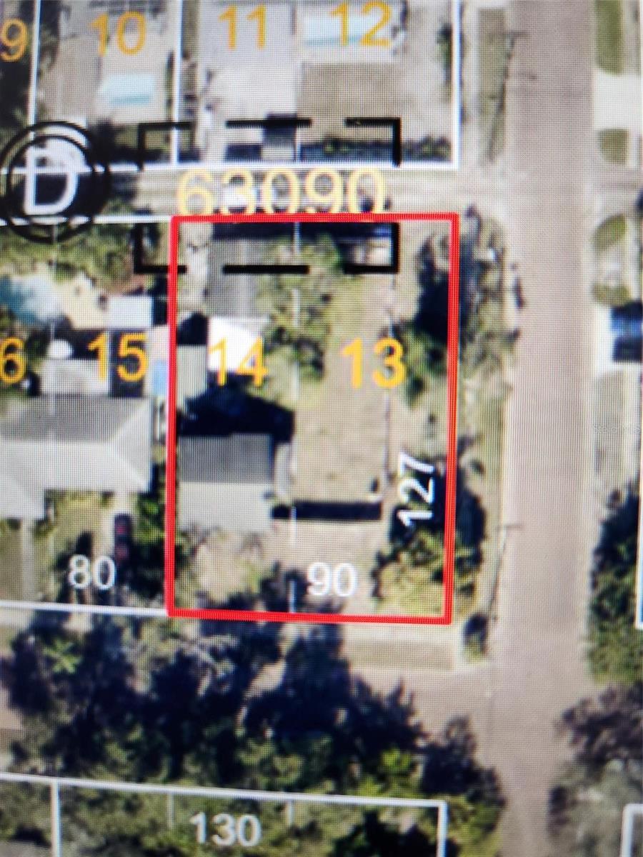 Aerial parcel map with one lot outlined in red among neighboring properties.