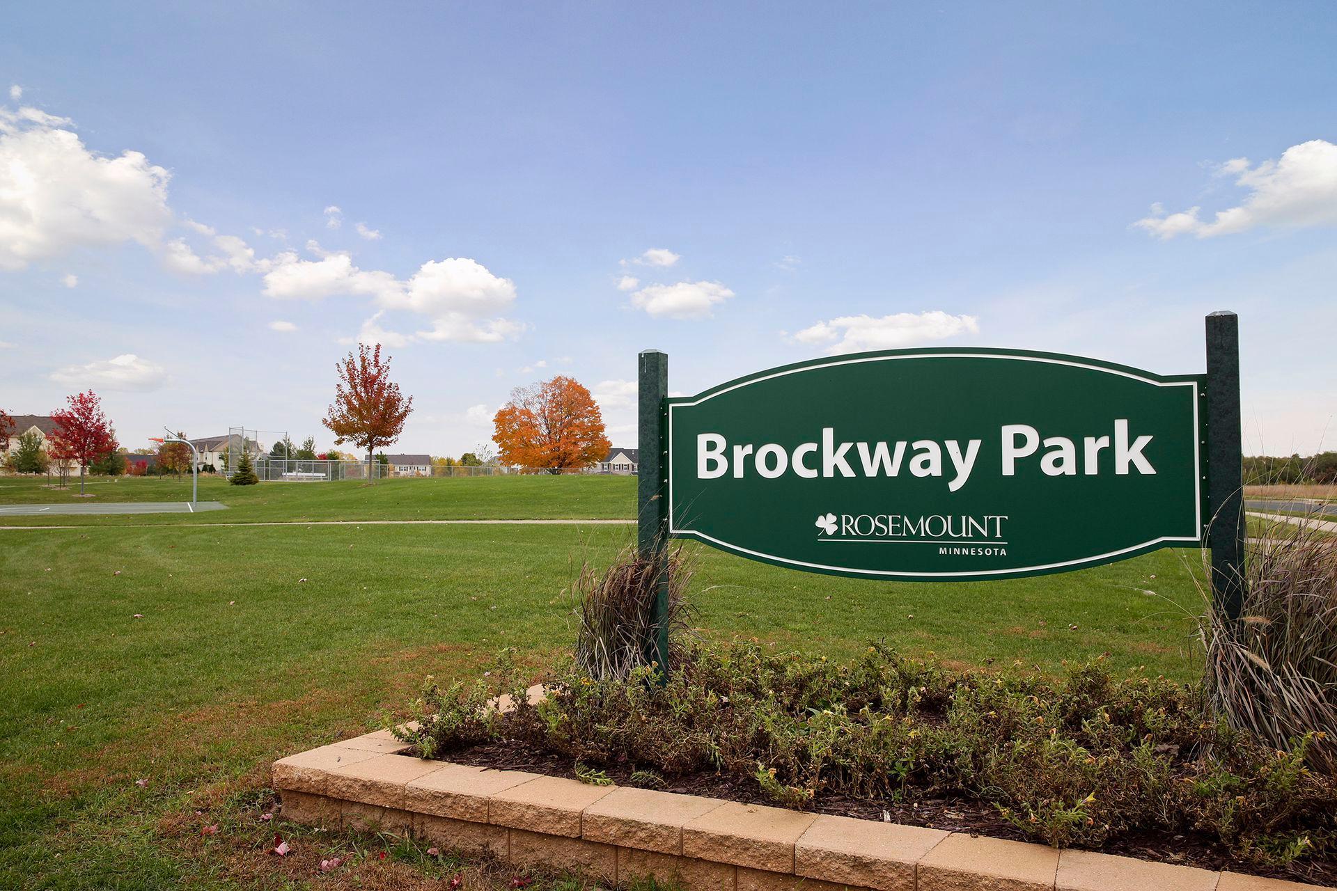 Brockway Park sign beside a grassy field and autumn trees in Rosemount, Minnesota.