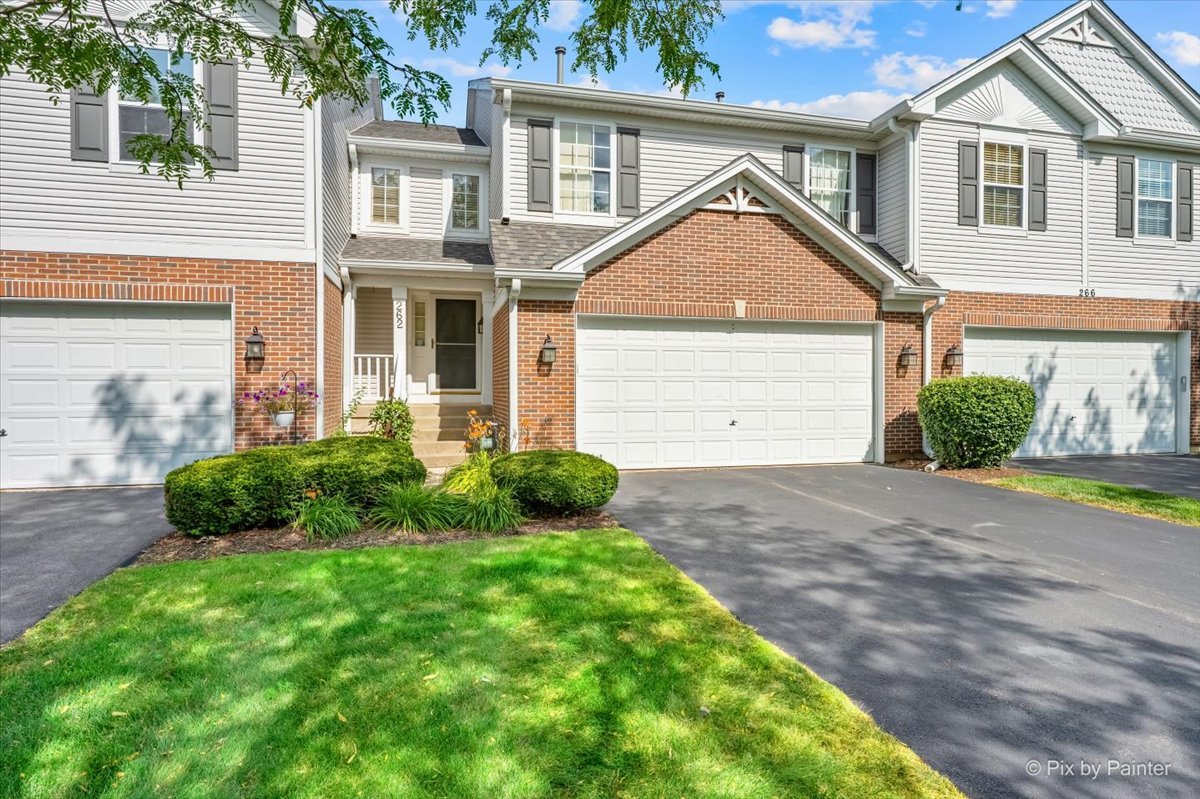 Townhouse at 262 Lineas Lane with a brick garage façade, landscaped lawn, and neighboring attached homes.