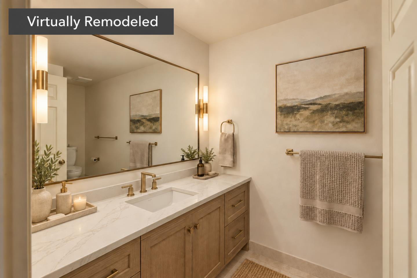 Bathroom with a marble-look vanity, wood cabinets, brass faucets, and a large mirror.
