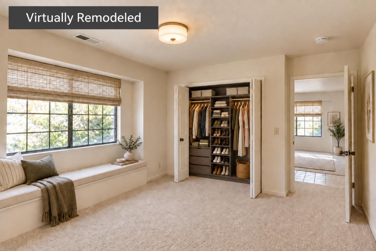 Bright carpeted bedroom with a window seat and an open, organized walk-in closet.