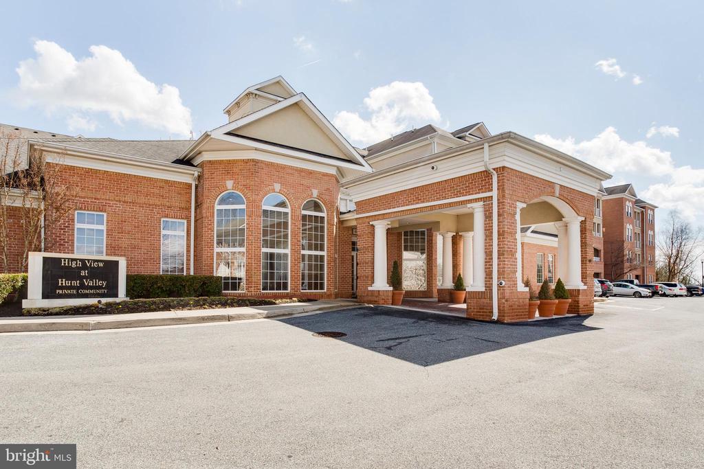 Red-brick High View at Hunt Valley entrance with arched windows and a covered porte cochere.