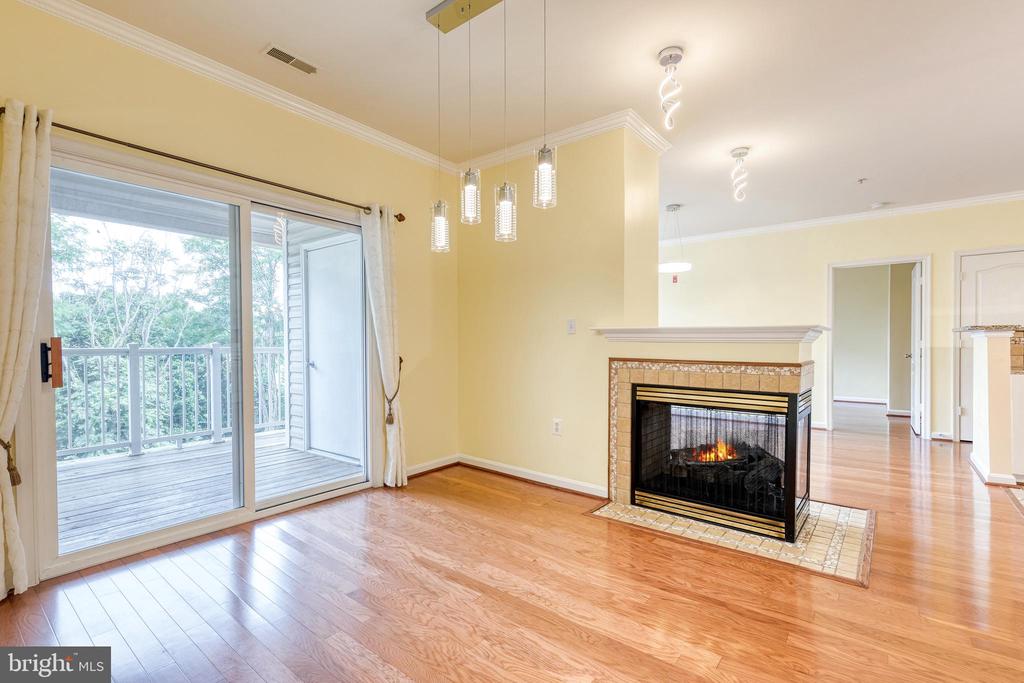 Unfurnished living room with a tiled fireplace and sliding glass doors to a balcony.