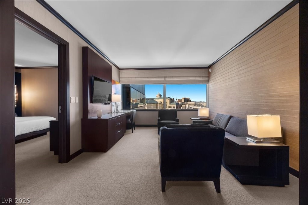 Furnished living area with dark seating, wood-paneled walls, and city views through large windows.