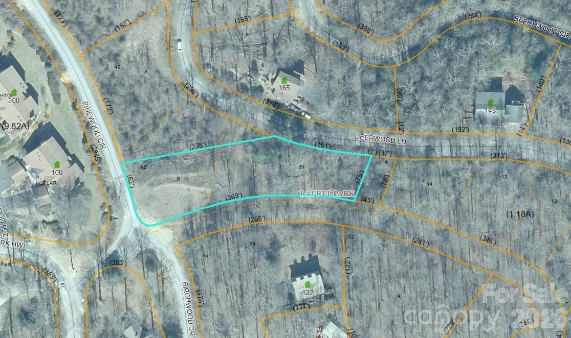 Aerial parcel map showing a turquoise-outlined wooded lot near Pinewood Circle and Deerwood Lane.