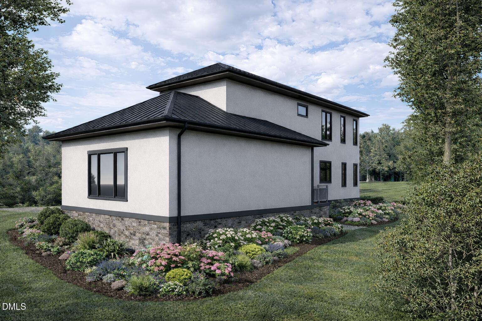 Modern two-story home with dark metal roofs and landscaped flower beds.