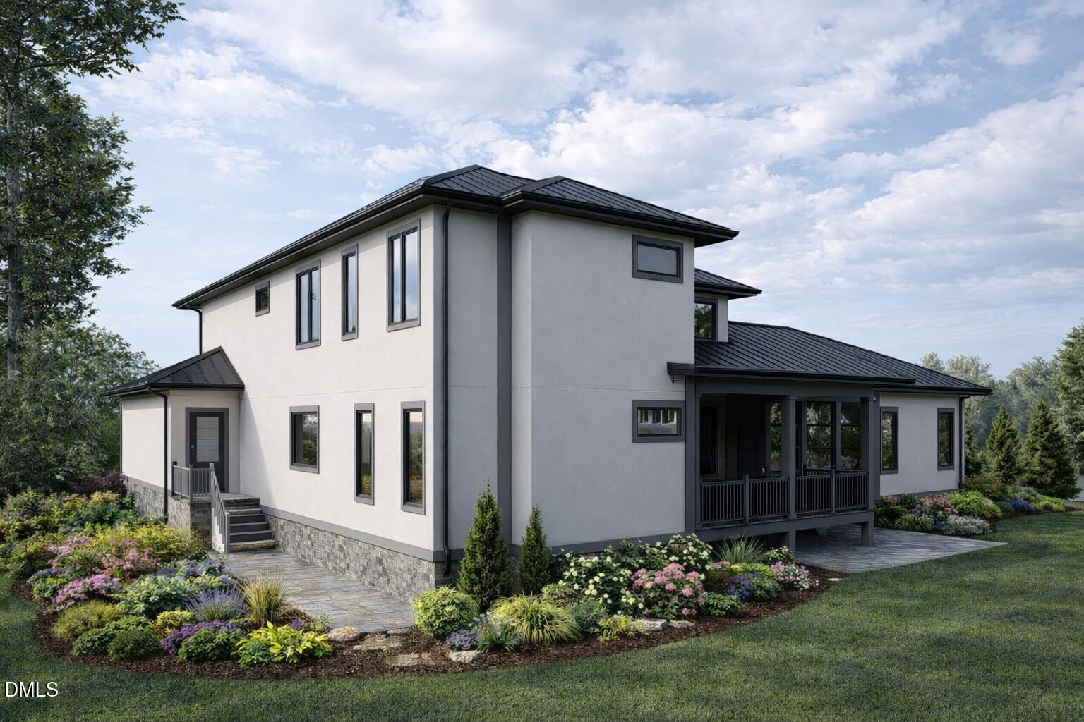 Modern two-story house with a dark metal roof, covered porch, and landscaped flower beds.
