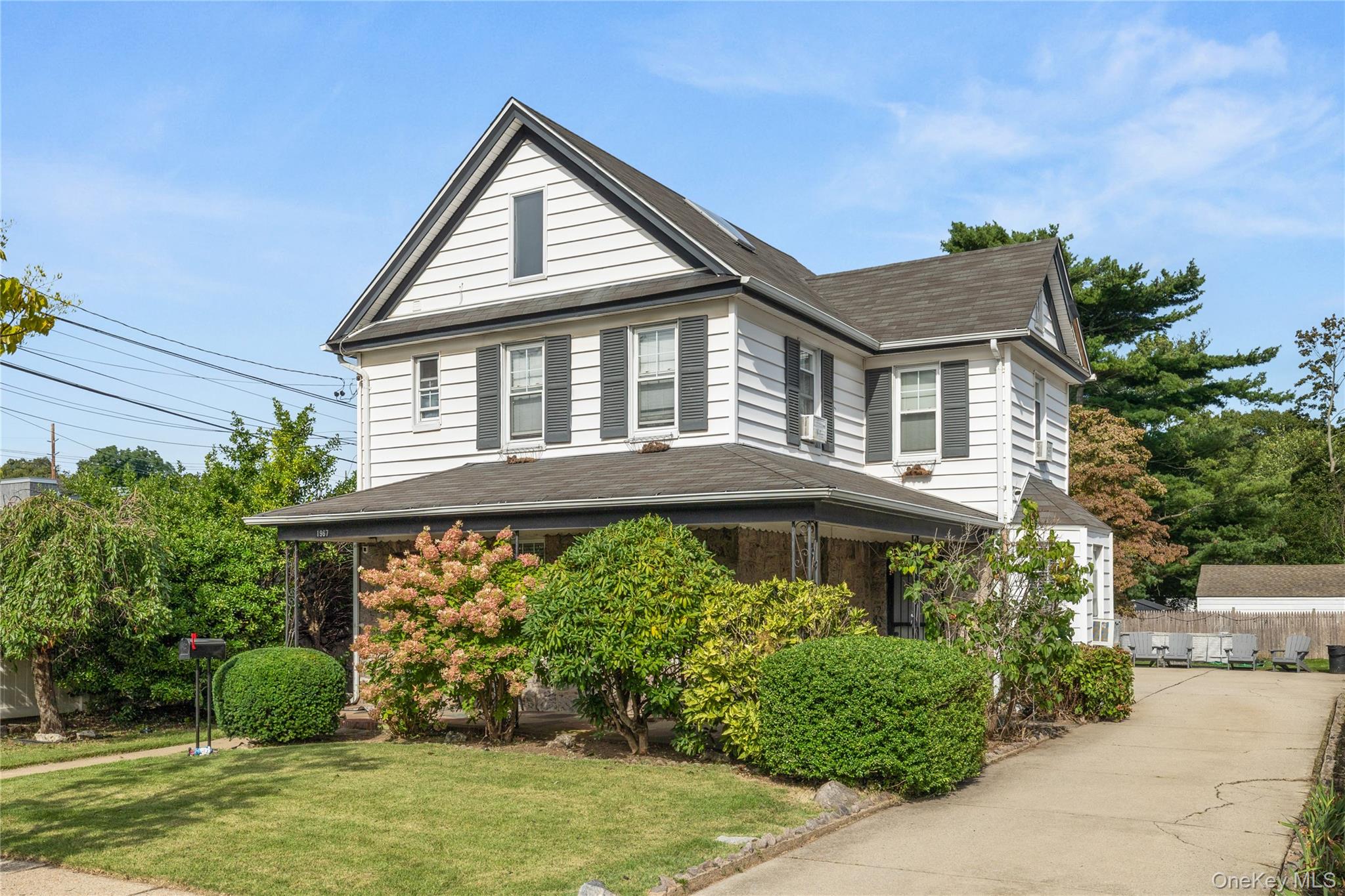 Ramsay Realtors office at 1967 Oakland Avenue, a white two-story house with dark shutters and a covered porch.