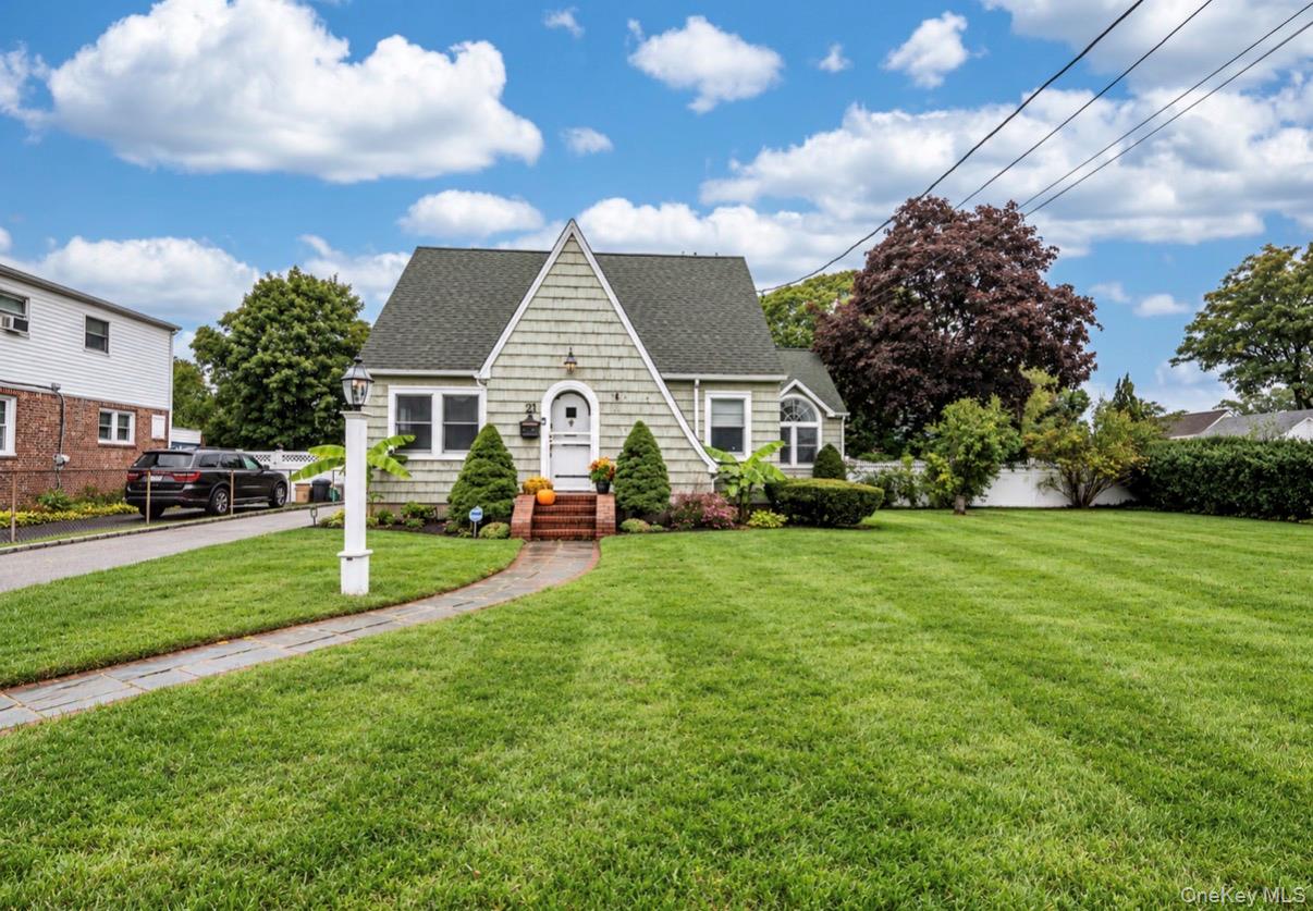 21 James Street with an arched front door, landscaped entrance, and broad green lawn.