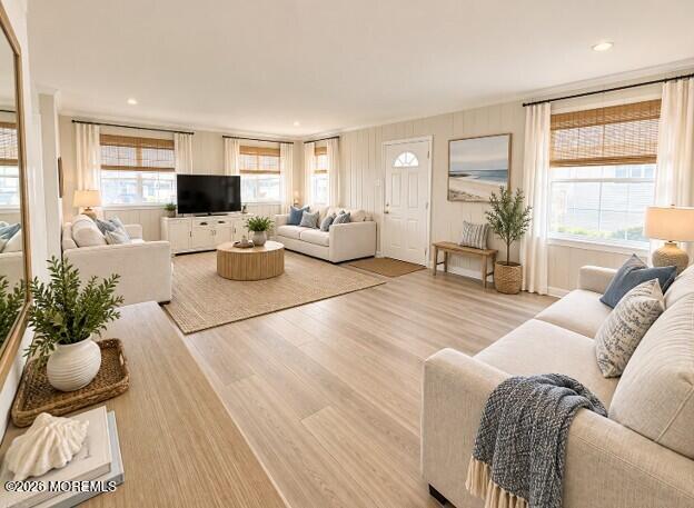 Staged living room with cream sofas, light wood floors, and woven window shades