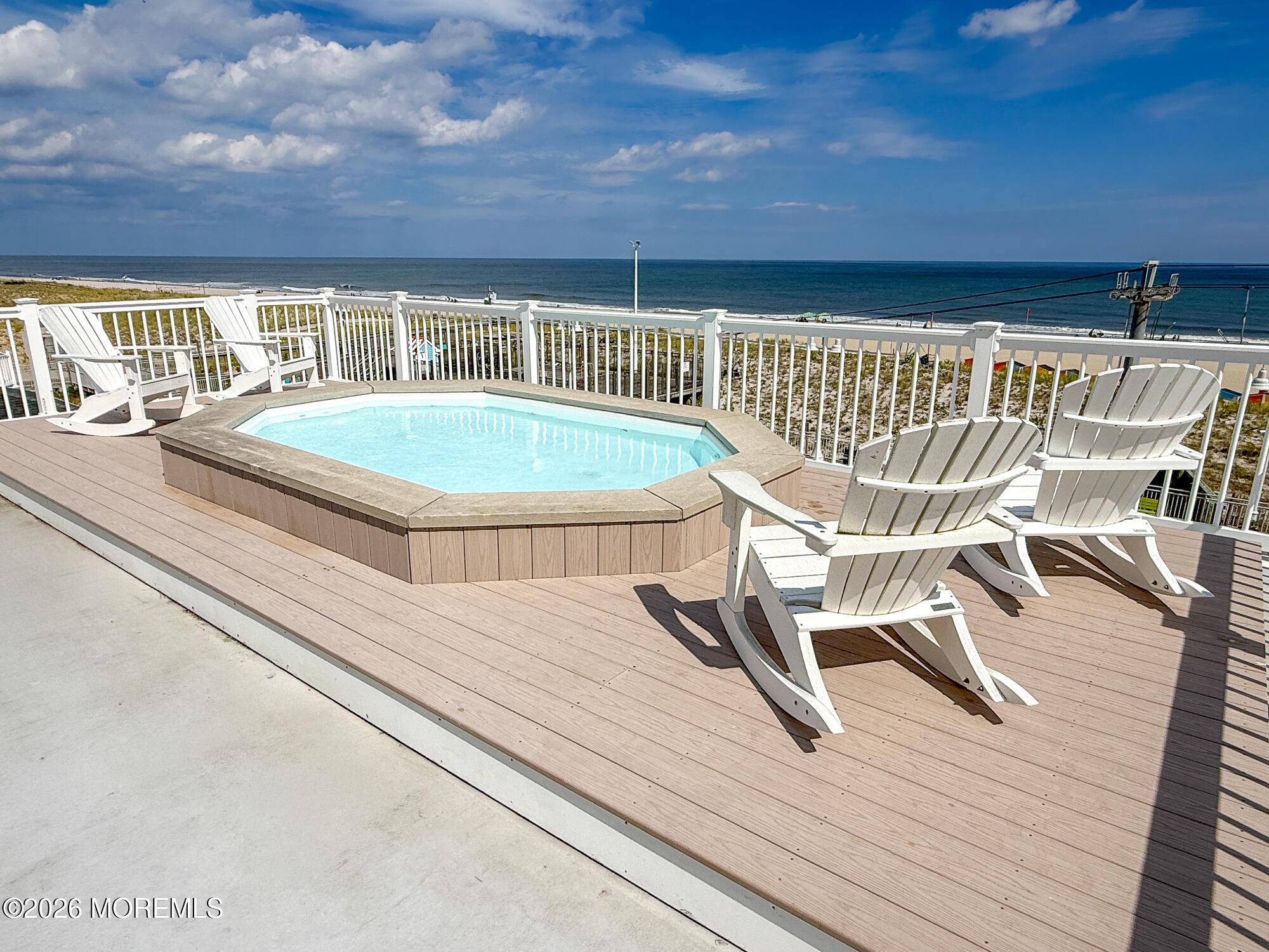 Deck hot tub and Adirondack chairs overlooking the ocean